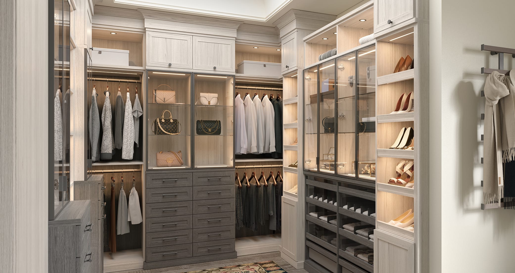 Walk in closet in light wood grain finish with shoe storage and custom LED lights by California Closets