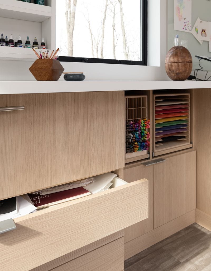 Storage drawers built into desk for a crafting room design by California Closets