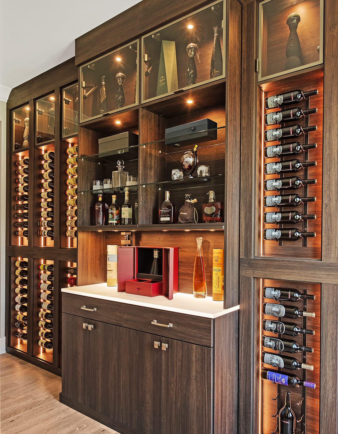 Luxe home bar design in dark wood grain finish custom made by California Closets