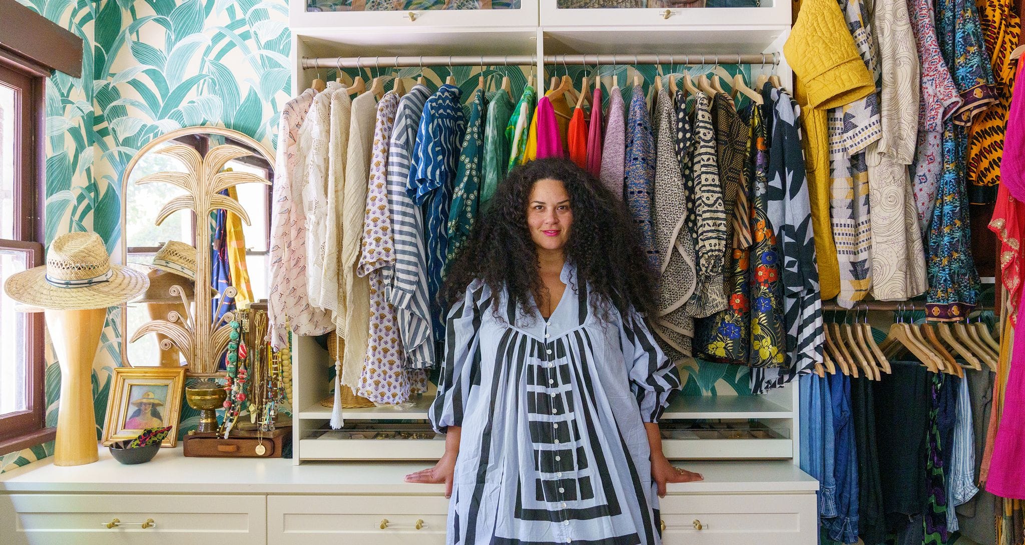 Custom walk in closet for Justina Blakeney's Jungalow home with open shelving by California Closets