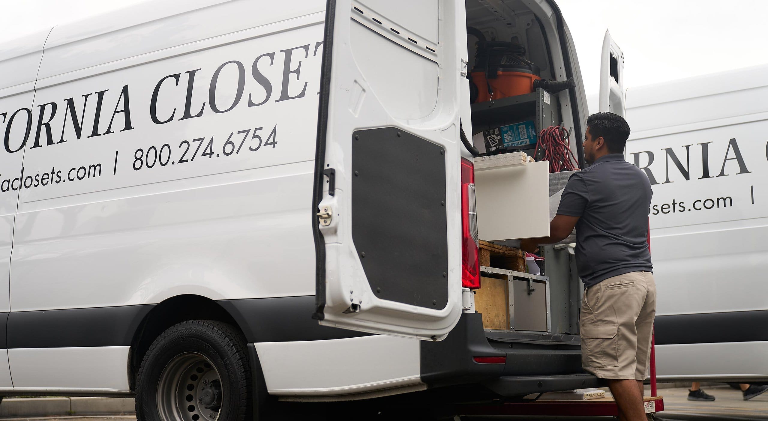 Installation technician at closet install jobsite moving building materials by California Closets